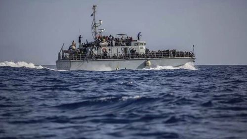 A photo released by the Libyan Coast Guard shows a ship with migrants off the coast of Libya, June 24, 2018.
