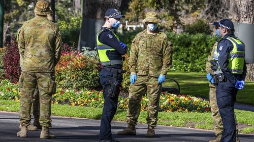 Australian Defence Force staff (ADF) and Victorian police are seen on patrol as a lockdown of Melbourne forces people to stay at home if not working, providing care or buying groceries.
