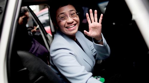 Maria Ressa, CEO and Executive Editor of online news site Rappler, waves as she attends a court hearing in Pasig City, Philippines.