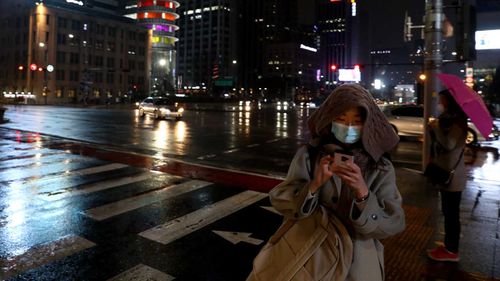 Pedestrians in Seoul, South Korea, wear face masks.