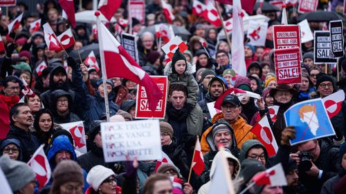 A crowd walks to the US consulate to protest against Trump's policy towards Greenland in Nuuk, Greenland, Saturday, Jan. 17, 2026. (AP Photo/Evgeniy Maloletka)