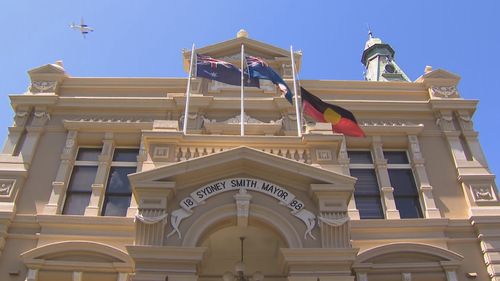 An Indigenous flag flies at half mast after the Voice referendum.