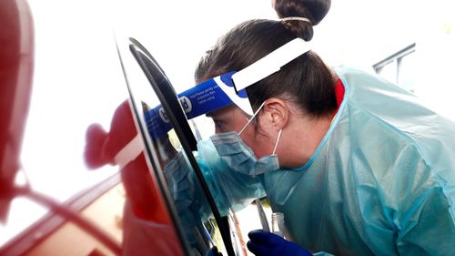 Medical professionals perform COVID testing at a drive through clinic in Ballarat, Victoria.