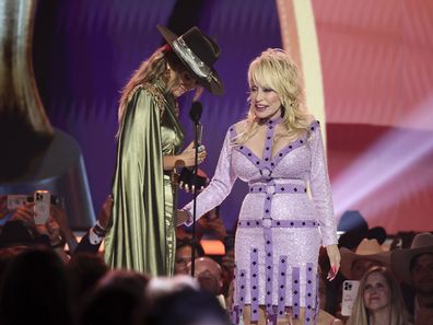 Lainey Wilson accepts the Female Artist of the Year award from co-host Dolly Parton onstage during the 58th Academy Of Country Music Awards at The Ford Center at The Star on May 11, 2023 in Frisco, Texas. 