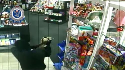 Police are hunting a masked man who was caught on CCTV in a Cessnock newsagency last month with a shotgun. Picture: Supplied.