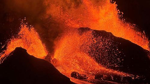 FILE - This image provided by the U.S. Geological Survey (USGS) shows evening views of lava fountaining from Haleumaumau Crater at the summit of Kilauea volcano inside Hawaii Volcanoes National Park, Hawaii., Feb. 11, 2025. (M. Patrick/U.S. Geological Survey via AP)