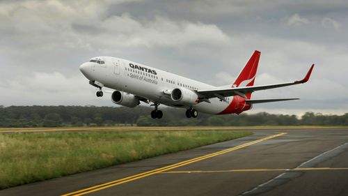 A Qantas Boeing 737-800 takes off from Melbourne Airport.