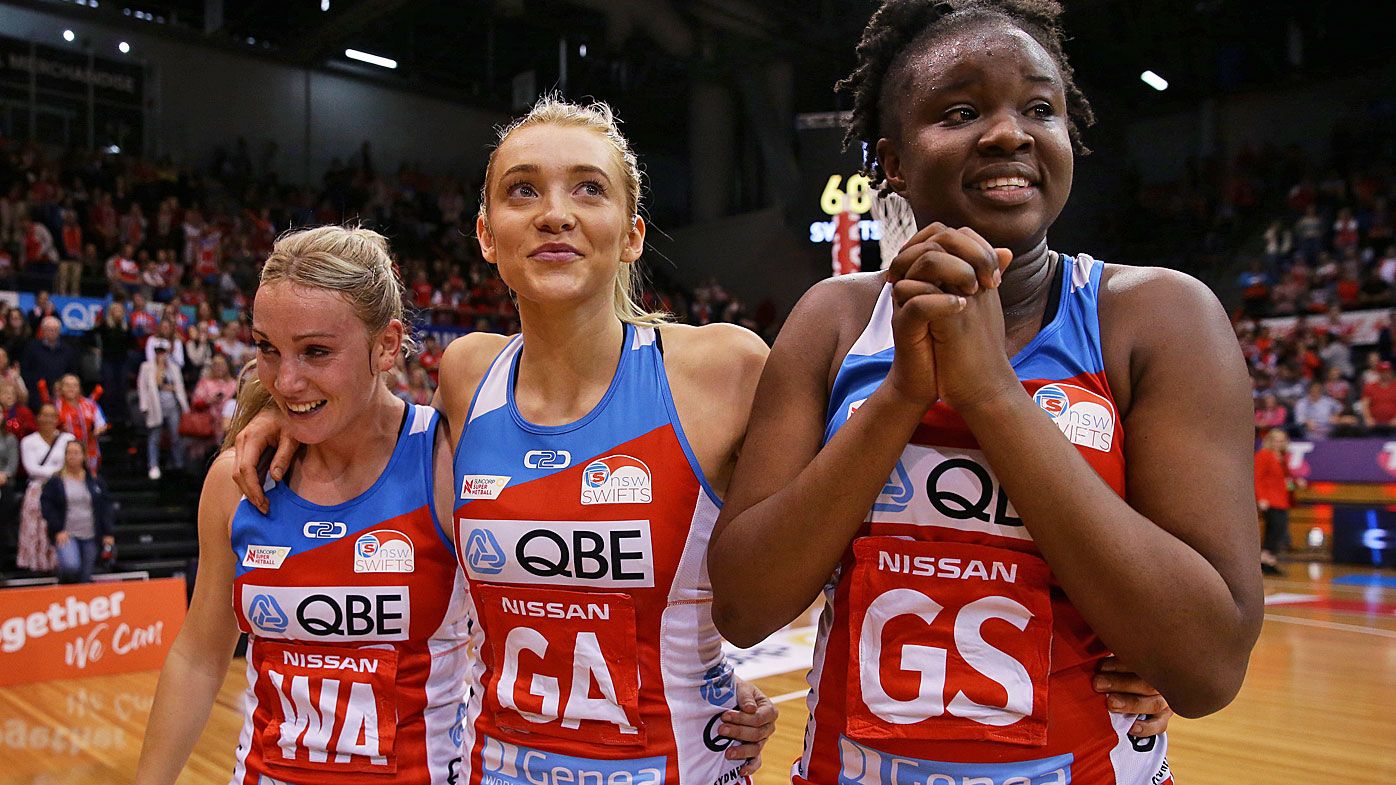 Natalie Haythornthwaite, Helen Housby and Sam Wallace of the Swifts celebrate after victory in the Super Netball Preliminary Final 