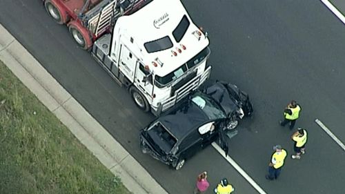 The crash occurred when a semi-trailer crossed a deep median strip and crashed into oncoming traffic. (9NEWS)