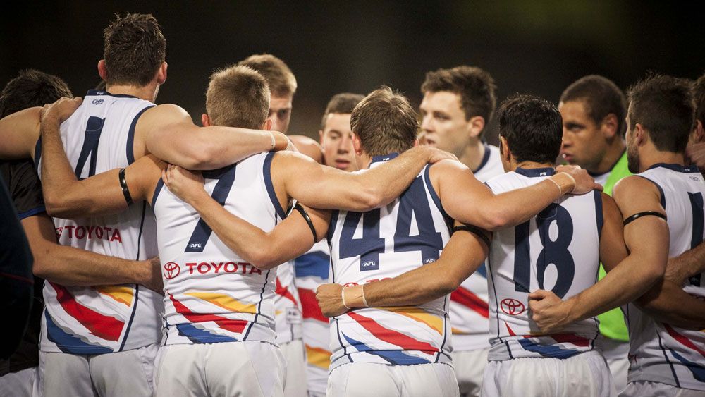 Adelaide Crows players in a huddle. (AAP)