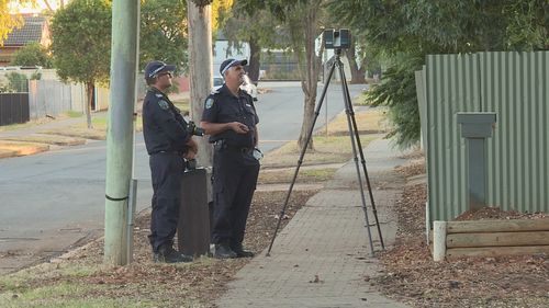 A man is fighting for life in hospital after being found lying in the street with serious head injuries in Adelaide.