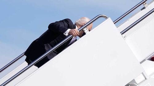 Joe Biden finds his feet after slipping on the steps up to Air Force One.