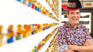 Brickman next to a wall of minifigs on LEGO Masters 2020.