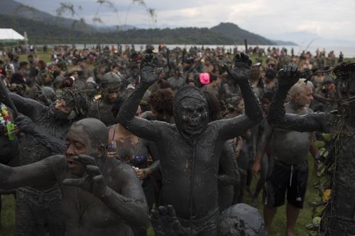 Revellers let loose, allowing plenty of sludge to fly. (AP)