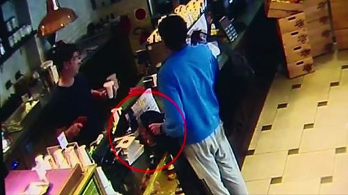 The thief placed his jacket over the jar while ordering a coffee. (9NEWS)