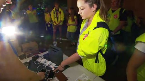 Safe Space volunteers providing phone chargers for people. (A Current Affair)