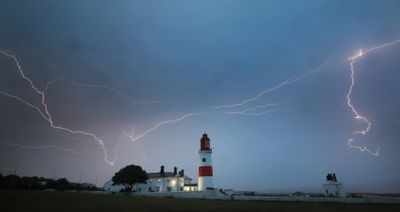 Lightning flashes over Souter lighthouse in South Shields as heavy thunderstorms gave some reprive from the heatwave last weekend in the UK.