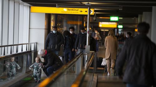 Arriving and departing passengers use the flat escalators at Schiphol Airport, near Amsterdam, Netherlands (Photo: December 18, 2020)