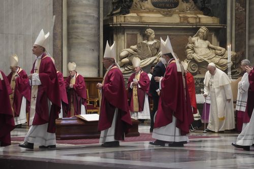 Pope Francis stands as cardinals and bishops leave after the funeral ceremony for Australian Cardinal George Pell in St. Peter's Basilica, at the Vatican, Saturday Jan. 14, 2023.  