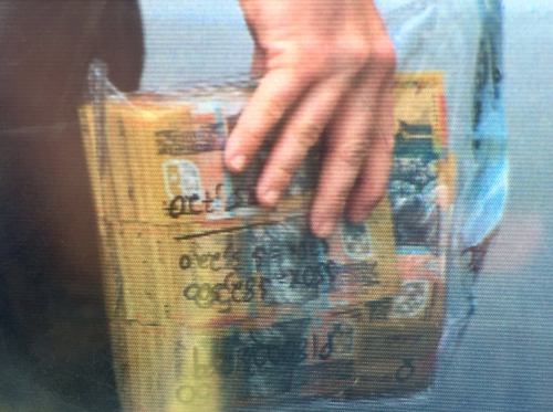 A bag of $50 notes was taken away by detectives. The figure $85,720 is written on the bag. (9NEWS)