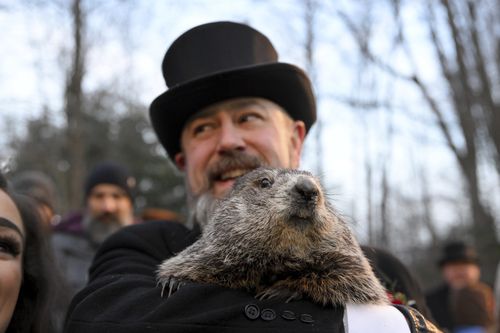 Groundhog Club handler A.J. Dereume holds Punxsutawney Phil, the weather prognosticating groundhog, during the 136th celebration of Groundhog Day on Gobbler's Knob in Punxsutawney, Pa., Wednesday, Feb. 2, 2022.