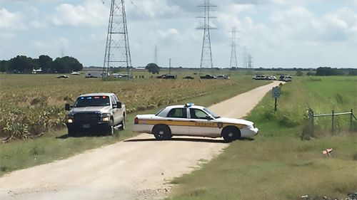 A police vehicle blocks a road where a hot air balloon crashed near Lockhart, Texas, July 30, 2016. (AFP/KXAN TV)