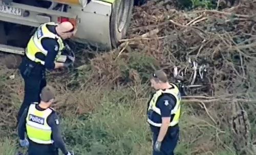 Police investigate the mangled wreck shortly after the crash. Picture: 9NEWS