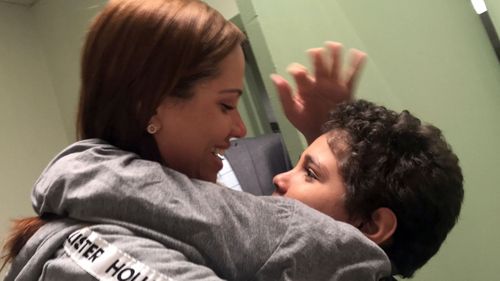 Lidia Karine Souza hugs her nine-year-old son Diogo for the first time since they were separated at the U.S.-Mexico border in May. (AAP)