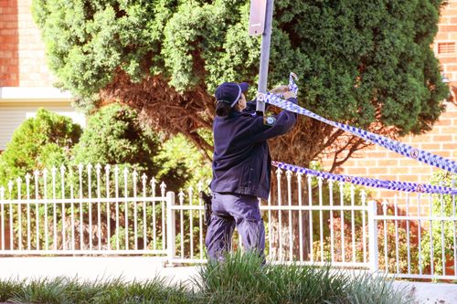 A police officer tapes off a crime scene after a body was found in burned car at Welfare Ave North in Beverly Hills. Friday, 18/04/2025. Photo: Dylan Coker / The Sydney Morning Herald