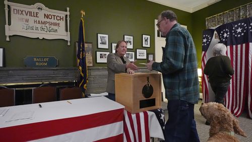 Voters cast their ballots during the midnight vote in the presidential election, Tuesday, Nov. 5, 2024, in Dixville Notch, N.H.