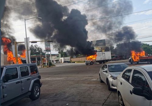 Vehicles on fire during a clash between armed gunmen and Federal police and military soldiers, in the streets of the city of Culiacan, Sinaloa state, Mexico.