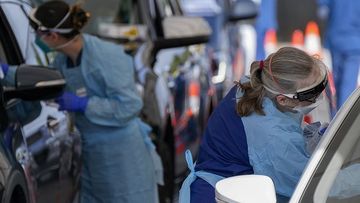 Staff collect samples at a drive-through COVID-19 testing clinic at Bondi Beach.