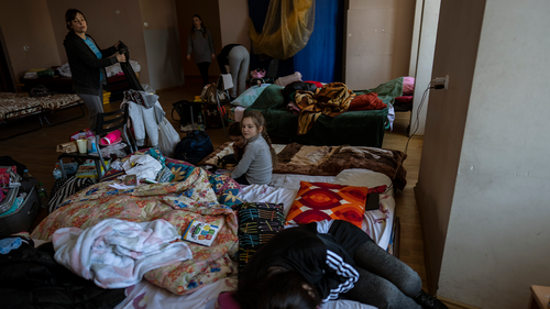 Families who fled the war in Ukraine stay inside a school in Przemysl, southeastern Poland, on Monday, March 14, 2022. 