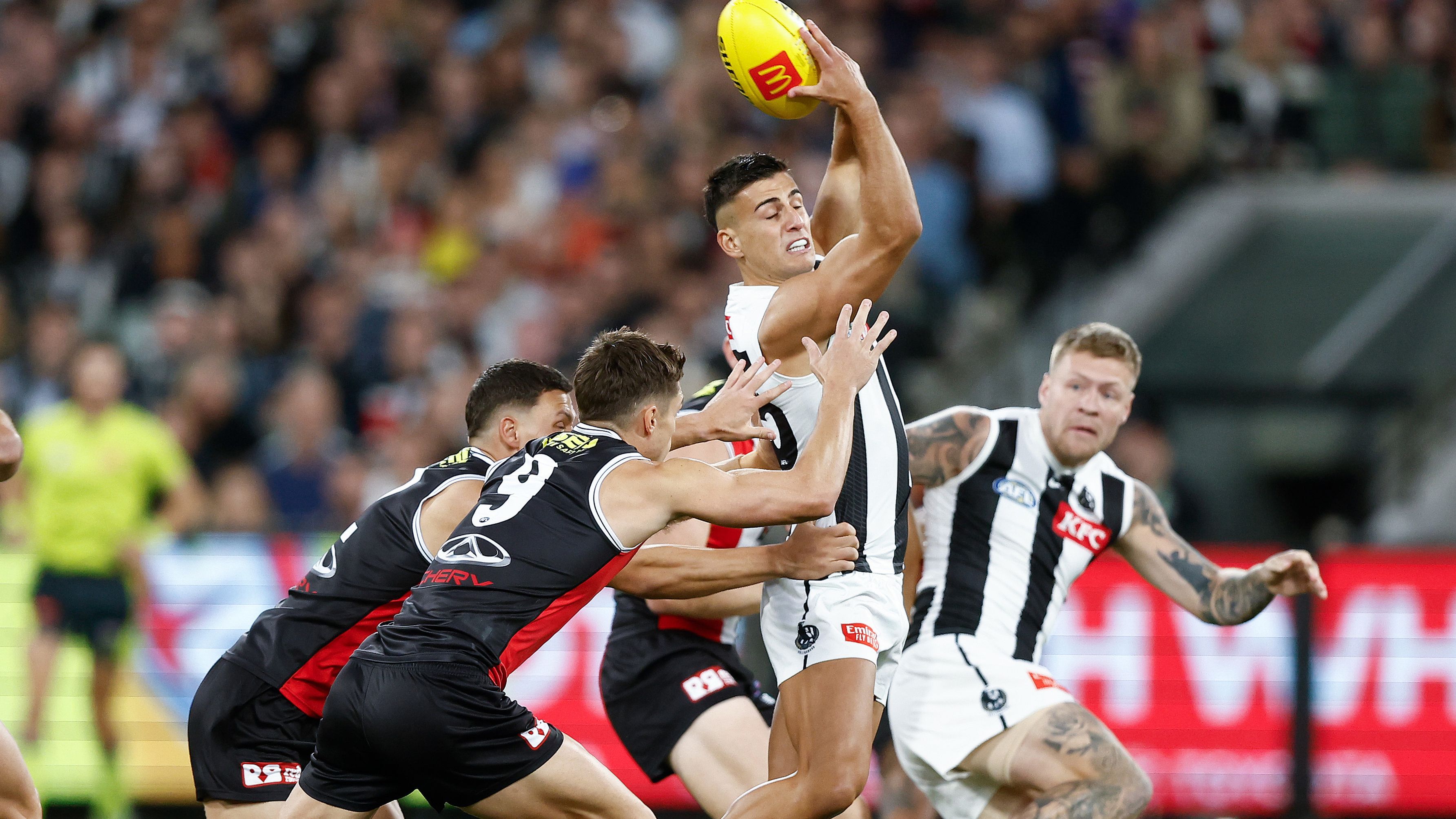 Nick Daicos of the Magpies handballs against St Kilda.