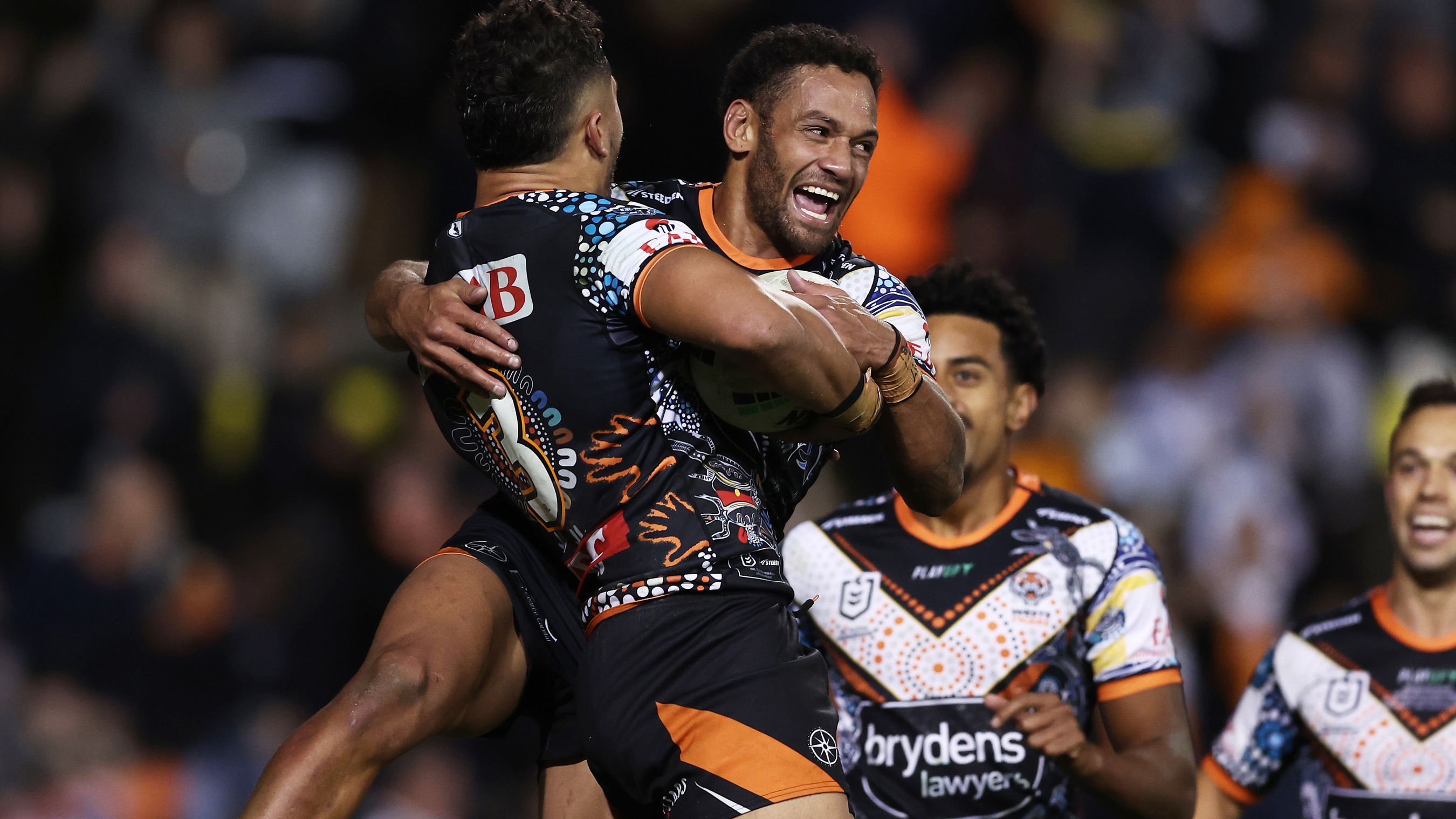 Starford To&#x27;a celebrates with Apisai Koroisau after scoring a try during the round 12 NRL match between Wests Tigers and North Queensland Cowboys.