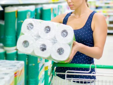Woman shopping for toilet paper