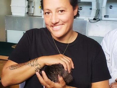 Allan at the Auckland Zoo holding a kiwi for the Department of Conservation and Kiwis.