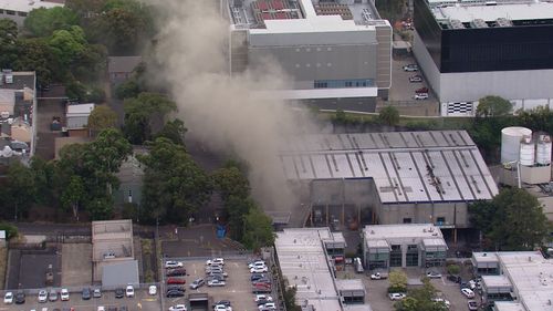 Thousands of residents living downwind from a fire in Sydney have been told to close their windows and doors as 80 firefighters battle a blaze at a waste facility.Two firefighters have been treated for heat exhaustion at the rubbish fire in Artarmon on the city's north shore which started this afternoon.