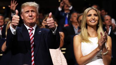 Donald Trump gives two thumbs up at the 2016 Republican National Convention as Ivanka Trump watches on and applauds.