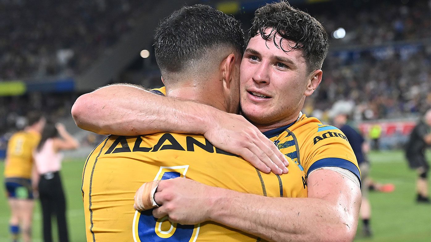 Dylan Brown and Mitchell Moses share an embrace