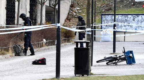 Swedish police search the area outside Varby Gard metro station, in Stockholm. (AAP)