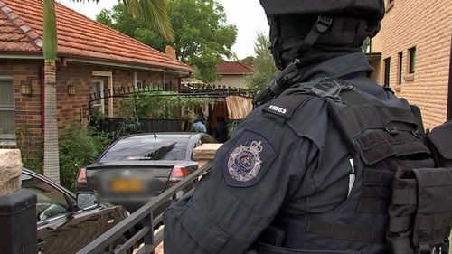 Police take the 25-year-old western Sydney man into custody this morning. (Photo: AAP).