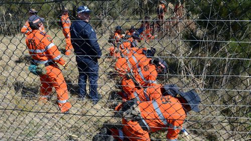 A file photo from 2012 shows SES volunteers and police conducting a search for the body of Patricia Riggs.