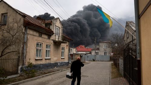 Smoke pours from a fire at an industrial facility after Russian military attack in the area in Lviv, Ukraine. 