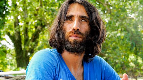 Refugee Behrouz Boochani poses for a photograph on Manus Island in 2017.