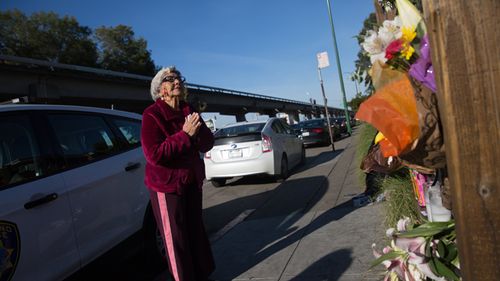 Lidia Marquez says a prayer December 4, 2016 for the victims near the site of a warehouse fire in Oakland, Califonia.