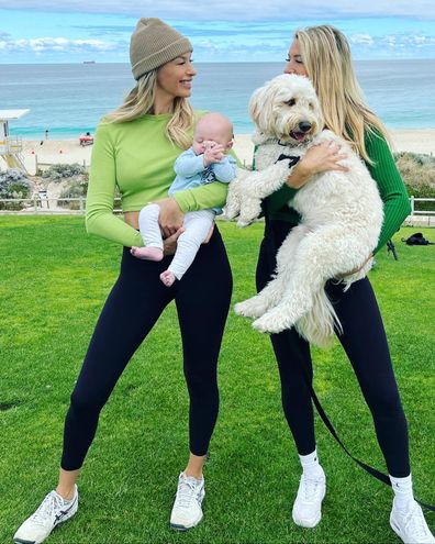Married At First Sight's Sharon and her twin sister Michelle from Season 4 posing with dog and child.