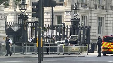 Police at the scene after a car collided with the gates of Downing Street in London Thursday May 25, 2023.