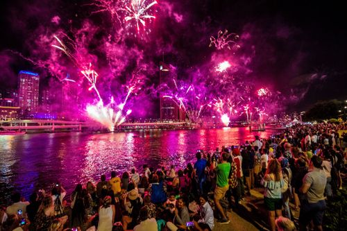 Revellers watch fireworks above Brisbane.