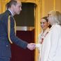 Prince William presents OBE to Emilia Clarke and her mum